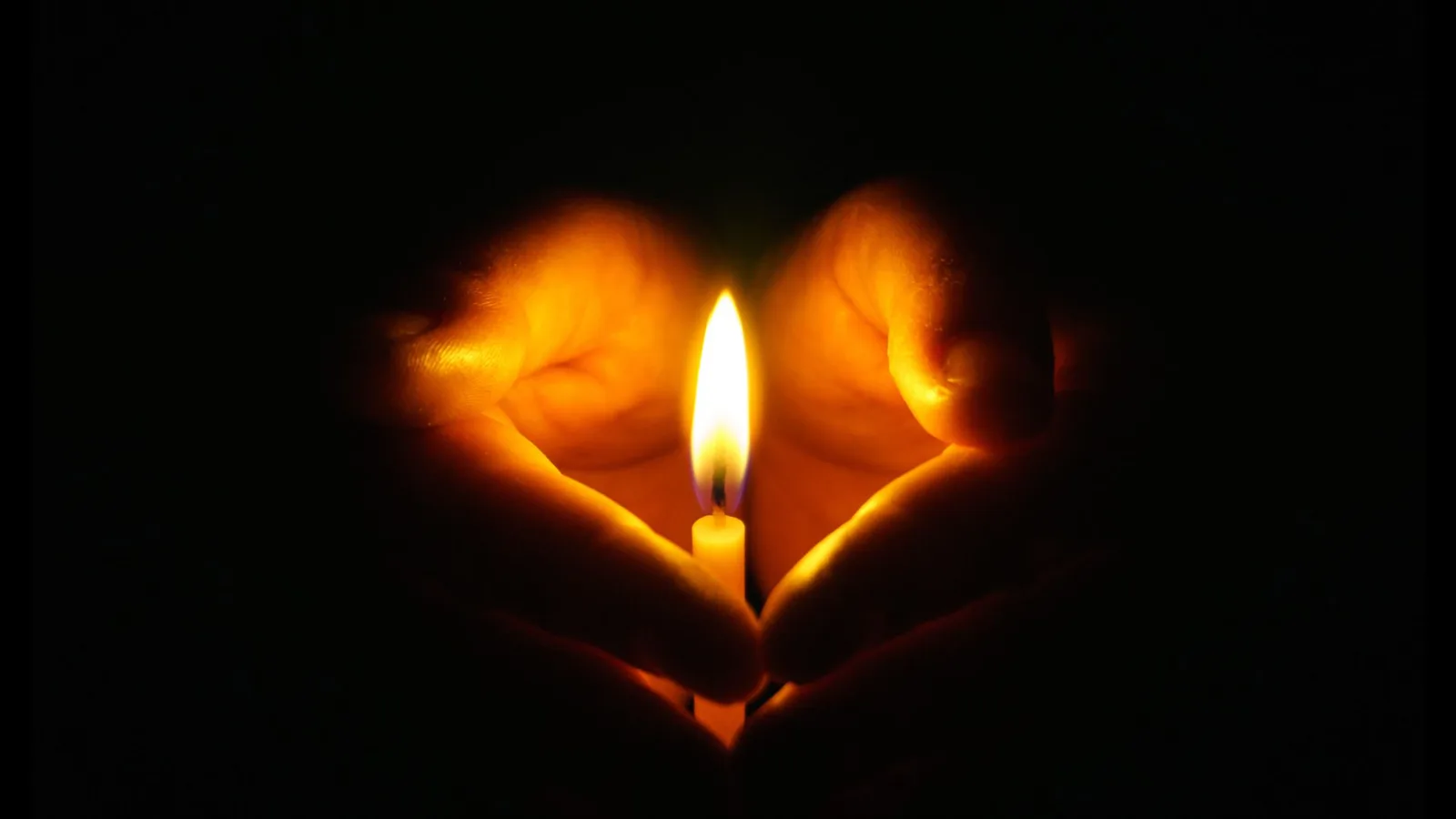 Hands holding a candle