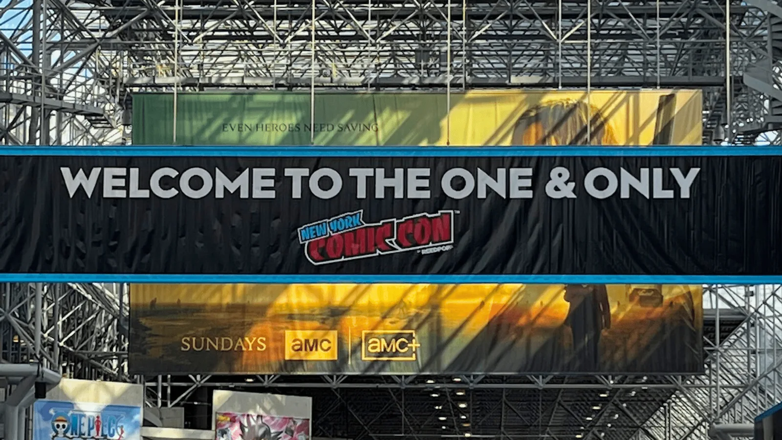 [A black banner hangs in the Javits Center that says "Welcome to the one & only (New York Comic Con Logo)]