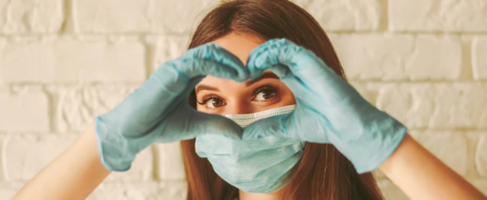 Banner of happy woman looks through hands in form of heart